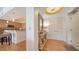 Stylish condo entryway with hardwood floors, console table, and partial kitchen view at 6512 Midnight Pass Rd # 206, Sarasota, FL 34242