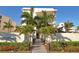 Beautiful condo exterior with manicured landscaping and walkway leading to the entrance at 6512 Midnight Pass Rd # 206, Sarasota, FL 34242