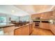 Open kitchen with wood cabinets, stainless steel appliances, and a breakfast bar overlooking the dining area at 6512 Midnight Pass Rd # 206, Sarasota, FL 34242