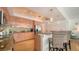 Contemporary kitchen featuring sleek wood cabinets, granite counters, and an island with seating at 6512 Midnight Pass Rd # 206, Sarasota, FL 34242