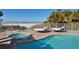 Community pool with a spa and lounge chairs overlooking the beach at 6512 Midnight Pass Rd # 206, Sarasota, FL 34242