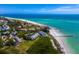 Panoramic aerial view of beachfront condos nestled along the coastline, offering stunning ocean views and easy beach access at 691 Linley St, Longboat Key, FL 34228