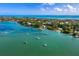 Breathtaking aerial view of a waterfront community with sailboats dotting the turquoise bay, showcasing a coastal lifestyle at 691 Linley St, Longboat Key, FL 34228