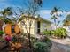 Backyard featuring a custom sauna, complemented by tropical landscaping and blue sky at 691 Linley St, Longboat Key, FL 34228