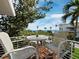 Outdoor balcony with water views, a white metal railing, and a table with chairs at 691 Linley St, Longboat Key, FL 34228