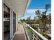 Relaxing balcony with sliding glass doors to the bedroom and lush landscaping at 691 Linley St, Longboat Key, FL 34228