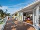 A home's exterior showing the deck with outdoor seating, adjacent to a living room at 691 Linley St, Longboat Key, FL 34228