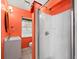 Bright bathroom features glass shower enclosure, vibrant paint, and vanity with sink at 691 Linley St, Longboat Key, FL 34228