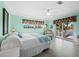 Bright bedroom featuring a ceiling fan, ensuite bathroom, and access to a private balcony at 691 Linley St, Longboat Key, FL 34228