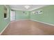 A large, open bedroom with tile floors, light-green walls, and a window at 691 Linley St, Longboat Key, FL 34228