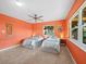 Bright bedroom with two twin beds, tile floors, an orange wall, and two windows at 691 Linley St, Longboat Key, FL 34228