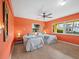 Bright bedroom featuring twin beds, colorful decor, tile floors, and a ceiling fan at 691 Linley St, Longboat Key, FL 34228