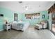 Serene bedroom featuring a ceiling fan, ensuite bathroom, and access to a private balcony at 691 Linley St, Longboat Key, FL 34228