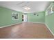 A spacious bedroom featuring tile floors, light-green walls, and multiple windows at 691 Linley St, Longboat Key, FL 34228