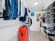 Walk-in closet features metal shelving filled with neatly organized clothing, creating storage space with a clean and organized aesthetic at 691 Linley St, Longboat Key, FL 34228