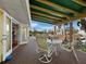 Outdoor deck with seating and dining, offering relaxation and entertainment space with an open view from the home's second story at 691 Linley St, Longboat Key, FL 34228