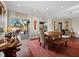 View from the dining room out to a deck with furniture and palm trees at 691 Linley St, Longboat Key, FL 34228