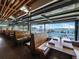 Cozy dining room with wooden booths and large windows overlooking the water at a waterfront restaurant at 691 Linley St, Longboat Key, FL 34228