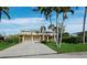 Inviting two-story home with a two-car garage, a spacious driveway, and lush landscaping at 691 Linley St, Longboat Key, FL 34228