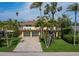 Coastal home with balconies, garage, and tropical landscaping at 691 Linley St, Longboat Key, FL 34228