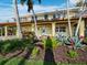 Well-maintained home with a lush front yard, mature landscaping, and ample parking space at 691 Linley St, Longboat Key, FL 34228
