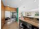Open kitchen with stainless steel appliances, breakfast bar, and seamless flow to the adjacent living areas at 691 Linley St, Longboat Key, FL 34228