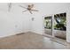 Bright living room with tile floors, ceiling fan, sliding glass doors leading to outdoor patio at 691 Linley St, Longboat Key, FL 34228