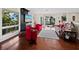 Cozy living room featuring vibrant furniture, wood floors, and access to outdoor balcony at 691 Linley St, Longboat Key, FL 34228