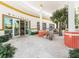 Inviting outdoor patio seating with a lush tree and glimpses of people dining at Whitney's restaurant at 691 Linley St, Longboat Key, FL 34228