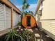 Exterior view of a wooden barrel sauna, nestled amidst lush tropical landscaping at 691 Linley St, Longboat Key, FL 34228