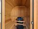 The interior view of a wooden sauna with a Harvia heater and wooden benches at 691 Linley St, Longboat Key, FL 34228