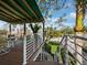 Staircase leading down from covered deck, offering easy access to the outdoor space and showcasing lush greenery in a beautiful design at 691 Linley St, Longboat Key, FL 34228
