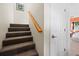 Carpeted stairs with wood railing lead to the upper level; bedroom is adjacent to stairs at 691 Linley St, Longboat Key, FL 34228