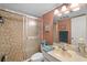 Cozy bathroom featuring a tiled shower with glass door and a neutral-toned vanity with sink at 7860 Palm Aire Ln # 104, Sarasota, FL 34243