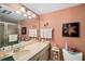 Bright bathroom with a large mirror, neutral tile shower, and decor for a fresh and clean feel at 7860 Palm Aire Ln # 104, Sarasota, FL 34243