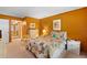 Comfortable bedroom featuring a queen bed, warm orange walls, and bright natural light for relaxing ambiance at 7860 Palm Aire Ln # 104, Sarasota, FL 34243
