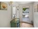 Bright entryway featuring a decorative mirror, sea shell art and a glimpse of the front porch at 7860 Palm Aire Ln # 104, Sarasota, FL 34243