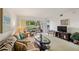 Sunlit living room featuring a neutral color palette, with access to the screened-in patio at 7860 Palm Aire Ln # 104, Sarasota, FL 34243