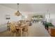 Spacious living room open to the dining area with a large window view of the outdoors at 7860 Palm Aire Ln # 104, Sarasota, FL 34243