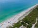 Expansive aerial view of the stunning white sand beach and emerald waters of the coast at 8430 Truman St, Englewood, FL 34224