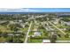 Aerial view of a residential neighborhood with lush trees, waterways, and the subject property at 8430 Truman St, Englewood, FL 34224