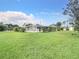 Expansive backyard featuring a well-maintained lawn and mature landscaping, perfect for outdoor activities at 8430 Truman St, Englewood, FL 34224