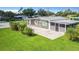 Beautiful home with a screened in porch and large paved patio in a well manicured lawn at 8430 Truman St, Englewood, FL 34224