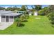 Spacious backyard featuring a covered patio, shade structure, and storage sheds at 8430 Truman St, Englewood, FL 34224