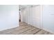 Spacious bedroom with two closets, modern floors, and a view to a hallway at 8430 Truman St, Englewood, FL 34224
