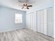 This bedroom is well-lit and has wood-look floors, a window, and a double closet at 8430 Truman St, Englewood, FL 34224