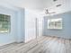 Bedroom showcasing wood-look floors, two closets, and lots of natural light from a window at 8430 Truman St, Englewood, FL 34224