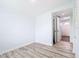 Bright bedroom showcasing stylish gray wood flooring and a doorway leading to the home's entrance at 8430 Truman St, Englewood, FL 34224