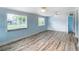Bright bedroom with wood floors, two ceiling fans, and well-lit windows at 8430 Truman St, Englewood, FL 34224