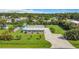 Charming single-story home featuring a well-maintained lawn and long concrete driveway at 8430 Truman St, Englewood, FL 34224
